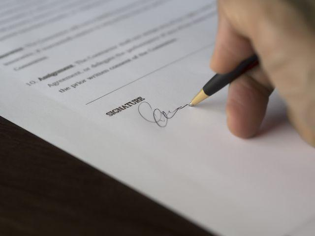 a person signing a lease agreement